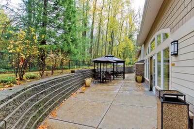 Outdoor seating area with gazebo and landscaped surroundings