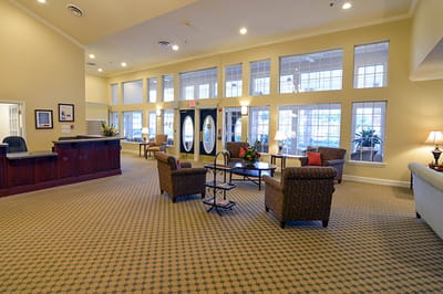Bright, welcoming lobby area with seating and plants