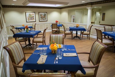 Interior dining area with tables set and floral centerpieces
