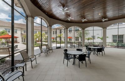 Covered outdoor seating area with tables and chairs