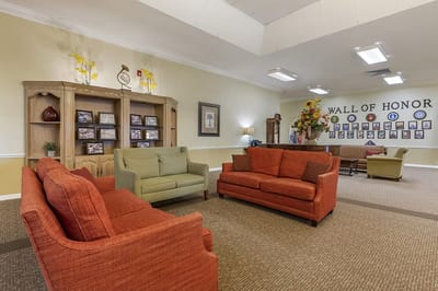 Common area with seating and a wall of honor