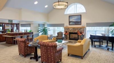 Bright common area with seating and fireplace