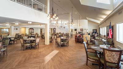 Bright dining area with tables and chairs for residents