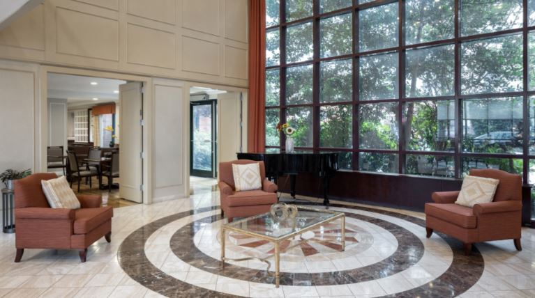 Bright interior common area with chairs and a piano