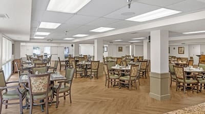 Brightly lit dining room with tables set for meals