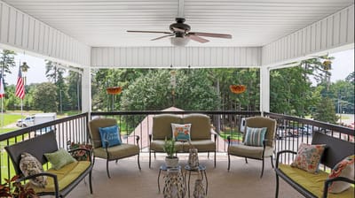 Outdoor patio seating area with plants and decorative pillows