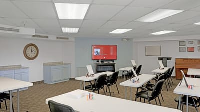 Interior view of an activity room with tables and chairs