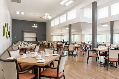 Bright dining room with tables set for meals