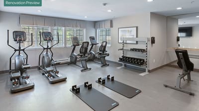 Fitness room with exercise equipment and mats