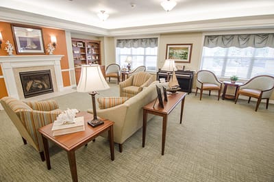 Well-decorated common area with seating and a fireplace