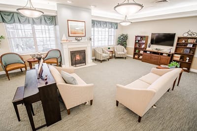 Bright common area with seating and fireplace