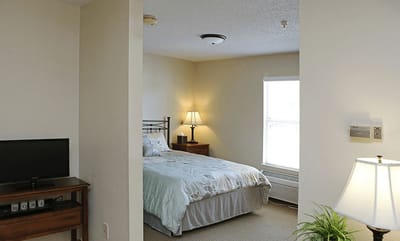 Private resident bedroom with bedding and furniture