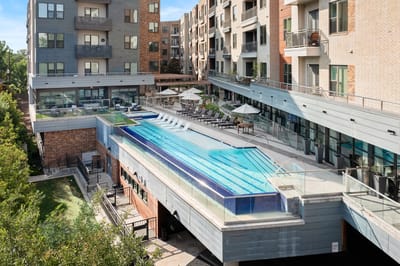 A modern outdoor pool area with lounge chairs
