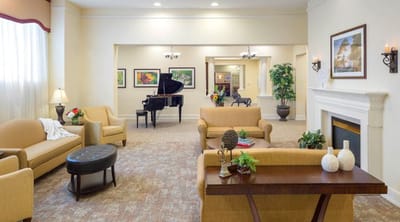 Bright common area with seating and piano