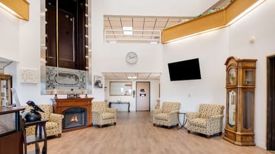 Bright lobby area with cozy seating and fireplace