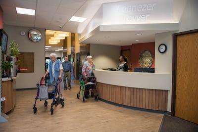 Residents walking in the lobby of Ebenezer Tower