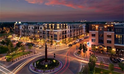 Exterior view of a mixed-use development at sunset