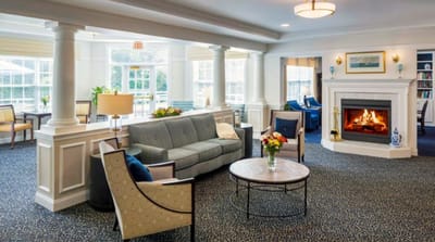 Bright interior common area with seating and fireplace