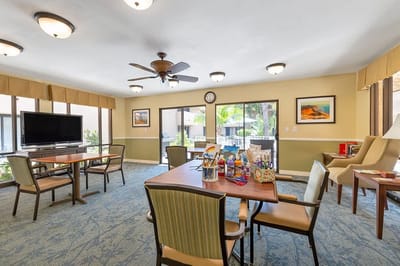 Bright common area with tables and chairs.