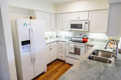 Modern kitchen interior with white appliances and cabinets