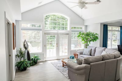 Bright common area with couch and large windows