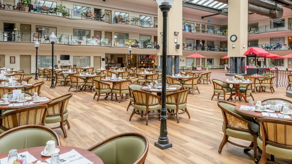 Dining area with tables and chairs in a bright atrium
