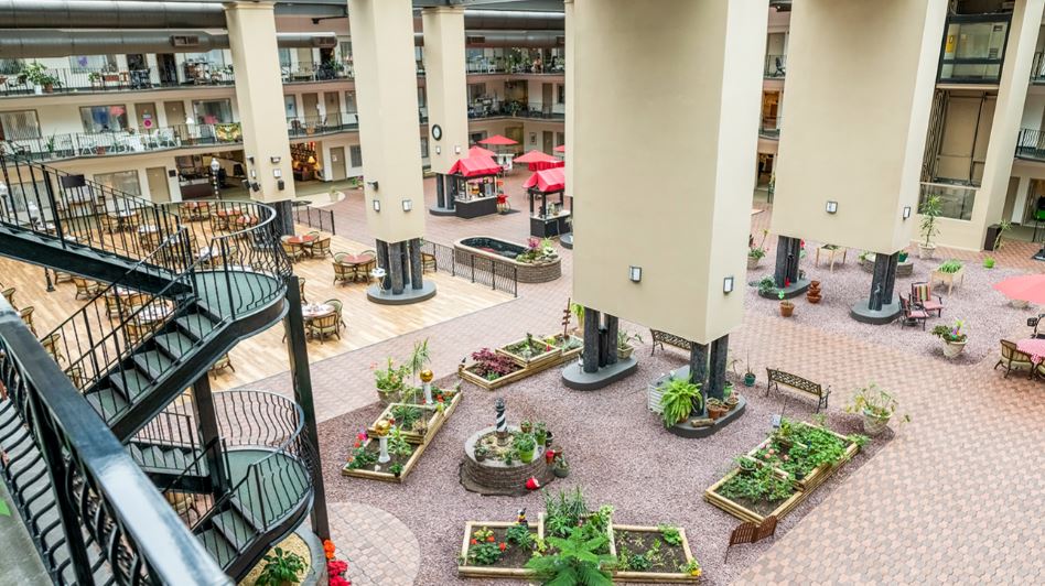 Aerial view of an indoor courtyard with gardens and seating