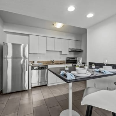 Modern kitchen setup with dining table and utensils