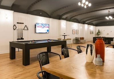 Common area with a pool table and seating.