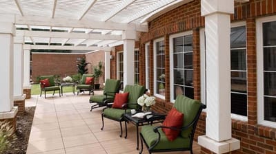 Outdoor patio seating area with chairs and flowers