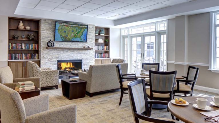 Bright common area with comfortable seating and a fireplace