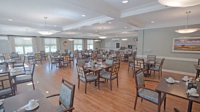 Bright dining room with tables set for meals