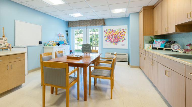 Bright common area with a table and chairs