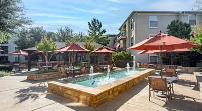 Outdoor space with seating and fountain in a senior living community