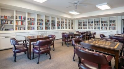 Bright common area with tables and bookshelves