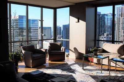 Bright common area with large windows and seating