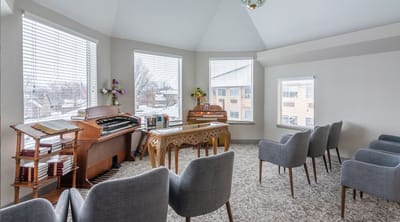 Bright interior common area with seating and instruments