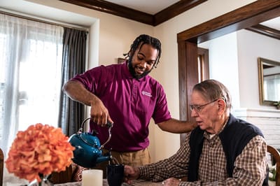 Home Instead – Philadelphia, home care in Philadelphia, PA — Caregiver pouring tea for a senior at the table