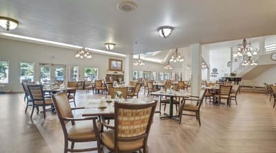 Bright dining room with tables and chairs set for meals