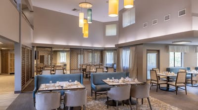 Bright and inviting dining room with tables set for meals