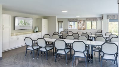 Bright activity room with tables and chairs