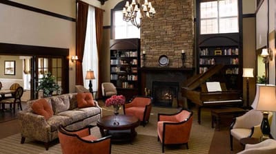Cozy lounge area with seating and a piano