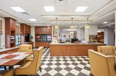 Interior view of a dining area with seating and kitchen
