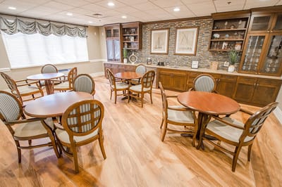 Bright common area with wooden tables and chairs