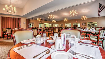 Dining area with beautifully set tables and chandeliers