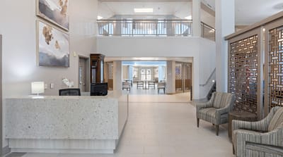 Bright and modern reception area with seating and decorative elements.