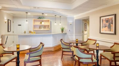 Bright common area with seating and a bar counter