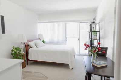 A cozy resident room with natural light and flowers