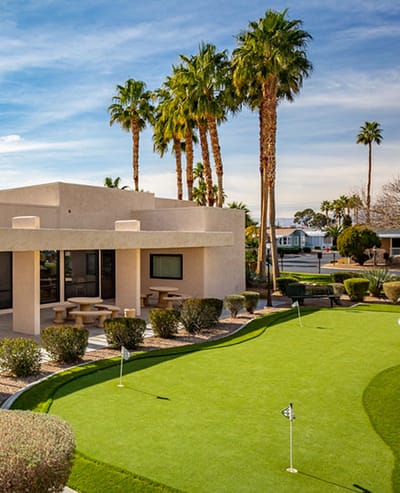 Outdoor view of the facility with palm trees and putting green