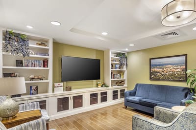 Cozy common area with seating and a large TV